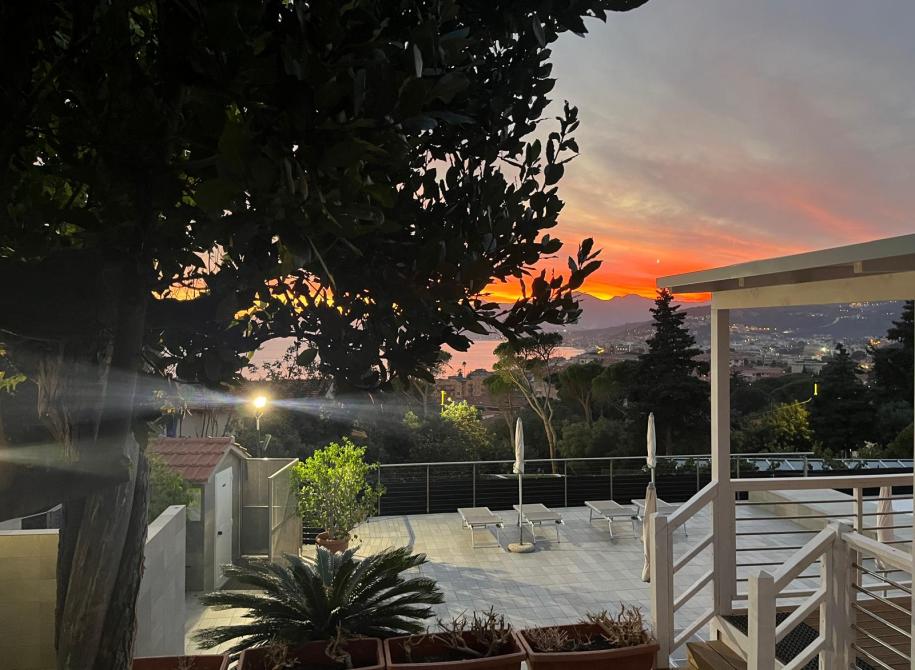 Breathtaking sunset over terrace, fiery sky, and illuminated city.